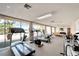 Bright gym space with treadmill and elliptical machines overlooking water at 700 Mirror Nw Ter # 505, Winter Haven, FL 33881