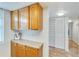 Hallway storage with wooden cabinets and hardware alongside an adjacent closet with sliding doors at 700 Mirror Nw Ter # 505, Winter Haven, FL 33881