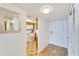 Hallway with wood-look flooring, mirror on the wall, and the kitchen in the background at 700 Mirror Nw Ter # 505, Winter Haven, FL 33881