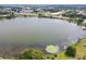 Still lake with lily pads and boats docked near grassy shoreline at 700 Mirror Nw Ter # 505, Winter Haven, FL 33881