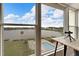 Scenic view from the condo window overlooking the lake, pool, and shuffleboard area at 700 Mirror Nw Ter # 505, Winter Haven, FL 33881