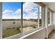 Lake view from a condo with views of a pool and lake, framed by a large window at 700 Mirror Nw Ter # 505, Winter Haven, FL 33881