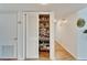 Pantry with shelving behind a louvered door at 700 Mirror Nw Ter # 505, Winter Haven, FL 33881