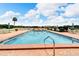 View of a clean pool, with a view of the lake beyond it at 700 Mirror Nw Ter # 505, Winter Haven, FL 33881