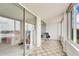Enclosed porch with sliding doors and tile floor at 700 Mirror Nw Ter # 505, Winter Haven, FL 33881
