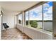 Enclosed porch featuring tiled floors and beautiful lake views at 700 Mirror Nw Ter # 505, Winter Haven, FL 33881