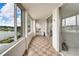 Enclosed porch with tiled floors and sliding glass doors to the lake at 700 Mirror Nw Ter # 505, Winter Haven, FL 33881