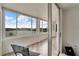 Screened porch with tile floor offers views of the lake beyond the wall of windows at 700 Mirror Nw Ter # 505, Winter Haven, FL 33881