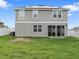 Large backyard with a lush lawn and exterior sliding doors at 1741 Hill Top Dr, Dundee, FL 33838