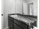 Bathroom featuring a sleek black marble vanity and a chrome faucet at 1741 Hill Top Dr, Dundee, FL 33838