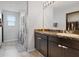 Bathroom with a marble countertop vanity, dark cabinets, a large mirror and a shower with curtain at 1741 Hill Top Dr, Dundee, FL 33838