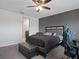 Comfortable bedroom featuring a ceiling fan, gray walls, black furniture and attached bathroom at 1741 Hill Top Dr, Dundee, FL 33838