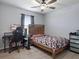 Bedroom with a gaming setup, ceiling fan, and a wood bed frame at 1741 Hill Top Dr, Dundee, FL 33838