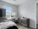 Bedroom features a vanity with lighted mirror and sleek gray dresser at 1741 Hill Top Dr, Dundee, FL 33838