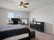 Bright bedroom with two windows, black furniture, and ceiling fan at 1741 Hill Top Dr, Dundee, FL 33838