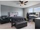 Bedroom featuring a ceiling fan, gray walls, black furniture and ample natural light from the window at 1741 Hill Top Dr, Dundee, FL 33838
