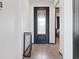 Bright foyer featuring wood-look tile flooring and an elegant black front door with glass inserts at 1741 Hill Top Dr, Dundee, FL 33838