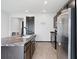 Contemporary kitchen with stainless steel appliances, dark cabinets, and a large island with granite countertops at 1741 Hill Top Dr, Dundee, FL 33838