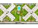Bird's eye view of condo complex with a swimming pool, manicured grounds, and unique X shaped buildings at 333 Lake Howard Dr Nw # 314D, Winter Haven, FL 33880