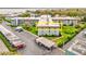Aerial view of a condo building in a complex with manicured green space and assigned parking at 333 Lake Howard Dr Nw # 314D, Winter Haven, FL 33880
