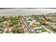 Aerial view of a condo complex with a lake view, lush landscaping, and nearby residential areas at 333 Lake Howard Dr Nw # 314D, Winter Haven, FL 33880
