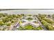 Aerial view of a waterfront condo complex featuring lush landscaping and covered parking at 333 Lake Howard Dr Nw # 314D, Winter Haven, FL 33880