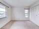 Bedroom featuring carpet flooring, a closet, and a bright window at 333 Lake Howard Dr Nw # 314D, Winter Haven, FL 33880