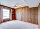 Cozy bedroom with wood paneling, a window and a closet at 333 Lake Howard Dr Nw # 314D, Winter Haven, FL 33880