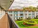 Exterior view of a condo complex featuring well-maintained grounds and mature landscaping at 333 Lake Howard Dr Nw # 314D, Winter Haven, FL 33880