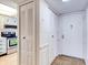Hallway featuring coat closets and entry door with kitchen view at 333 Lake Howard Dr Nw # 314D, Winter Haven, FL 33880