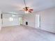 Bright living room with neutral walls and carpet, featuring a ceiling fan at 333 Lake Howard Dr Nw # 314D, Winter Haven, FL 33880