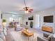 Open living room featuring neutral decor, ceiling fan, and modern furniture at 333 Lake Howard Dr Nw # 314D, Winter Haven, FL 33880