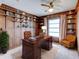 Office with hardwood paneling, built in shelving, and neutral carpet at 333 Lake Howard Dr Nw # 314D, Winter Haven, FL 33880