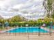 The community pool is surrounded by wrought iron fencing and landscaping at 333 Lake Howard Dr Nw # 314D, Winter Haven, FL 33880