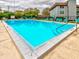 Community pool with lounge chairs and building in background at 333 Lake Howard Dr Nw # 314D, Winter Haven, FL 33880