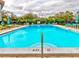 The community pool provides ample lounge seating with shade and blue umbrellas at 333 Lake Howard Dr Nw # 314D, Winter Haven, FL 33880