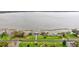 Waterfront view showing calm lake waters, a private pier, and lush green landscaping at 333 Lake Howard Dr Nw # 314D, Winter Haven, FL 33880