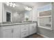 Bright bathroom with a double vanity, granite counters, a large mirror, and natural light from a window at 3798 Plainview Dr, Orlando, FL 32824