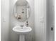 Stylish powder room with a pedestal sink and modern fixtures at 3798 Plainview Dr, Orlando, FL 32824