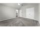 Spacious bedroom with neutral walls, plush carpet, a ceiling fan, and an en-suite bathroom entrance at 3798 Plainview Dr, Orlando, FL 32824