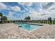 Community pool featuring brick pavers, lounge chairs, umbrellas, and a serene setting at 3798 Plainview Dr, Orlando, FL 32824