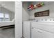 Convenient laundry room with modern appliances and cheerful decor, adjacent to a bedroom for easy access at 3798 Plainview Dr, Orlando, FL 32824