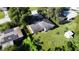 An aerial view of a single-story home with a large yard surrounded by mature trees and a neighboring house at 111 2Nd St # Jpv, Winter Haven, FL 33880