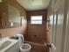 Classic bathroom featuring a tiled shower-tub combo, a toilet, and a small vanity, ready for renovation at 111 2Nd St # Jpv, Winter Haven, FL 33880