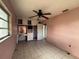 Bedroom featuring tile flooring, a ceiling fan, and a built-in vanity, providing a comfortable and customizable space at 111 2Nd St # Jpv, Winter Haven, FL 33880