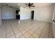 Spacious living room featuring neutral tile flooring, a ceiling fan, and ample natural light, ready for your personal touch at 111 2Nd St # Jpv, Winter Haven, FL 33880