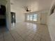 Bright living room with tile flooring and a ceiling fan, illuminated by natural light from a large window at 111 2Nd St # Jpv, Winter Haven, FL 33880