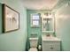 Bright bathroom featuring a toilet, sink, mirror, and a whimsical, beachy theme at 1404 N Atlantic Ave # 270, Daytona Beach, FL 32118