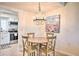 Cozy dining area with a chandelier, beach art, and an open view into the kitchen space at 1404 N Atlantic Ave # 270, Daytona Beach, FL 32118