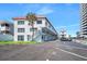 Exterior view of a multi-story condo complex with well-maintained parking and landscaping at 1404 N Atlantic Ave # 270, Daytona Beach, FL 32118